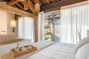 a bedroom with a large bed and a large window at Suite della Torre in Cavernago