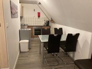 a kitchen with a table and chairs in a room at FeWo Heaven in Winterberg +4 photos
