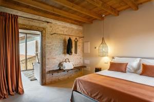 a bedroom with a bed and a brick wall at Suite della Torre in Cavernago