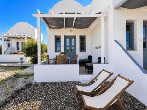 a view of the front of a house with chairs at Mare Nostrum Santo in Oia