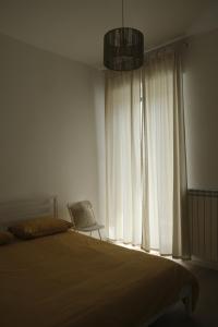 a bedroom with a bed and a large window at Amati Bed & Breakfast in Lecce