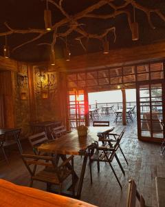 a dining room with tables and chairs in a building at Indra Village Hotel in Pazar
