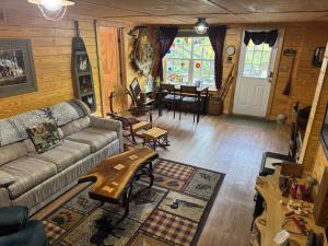 a living room with a couch and a table at Charming Rustic Barn in Spruce Pine