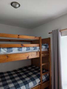 a couple of bunk beds in a room at Scoor House - Cnoc Mor in Bunessan