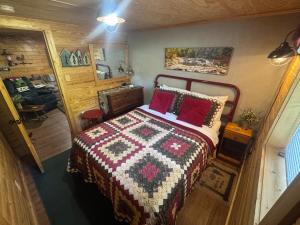 a bedroom with a bed with a quilt on it at Charming Rustic Barn in Spruce Pine