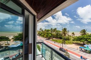 a view of the beach from the balcony of a building at João Pessoa Hplus Beach in João Pessoa