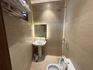 a bathroom with a sink and a toilet and a mirror at سقيا طيبة Suqya Taiba in Medina +53 photos