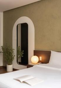 a bedroom with a bed and a large mirror at V Living - Downtown Saigon Stay with Free Laundry in Ho Chi Minh City