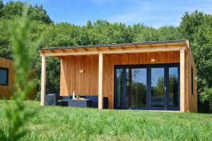 a house with a large glass door in a yard at Cabañas Compostela - Cabaña Bosque Encantado in Santiago de Compostela