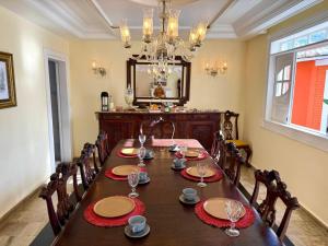 a dining room with a table with chairs and a chandelier at Terra do Sol Pousada - Passarela in Porto Seguro