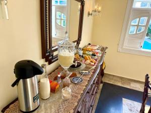 a table with a blender and a drink on it at Terra do Sol Pousada - Passarela in Porto Seguro