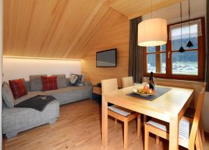 a living room with a table and a couch at Ferienwohnungen Erath in Schoppernau