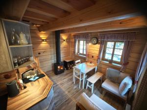 an overhead view of a kitchen and living room of a log cabin at Roubenka a miniroubenka, Olšany in Olšany