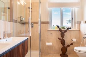 a bathroom with a shower and a toilet and a sink at Residence Verdeluna in Marina di Pietrasanta +42 photos