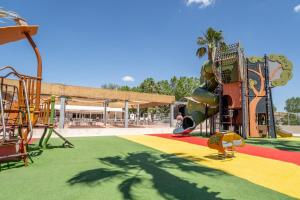 a park with a playground with a slide at Camping Valras plage 5 étoiles in Vendres