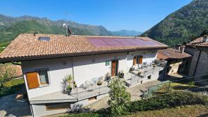 a house with a solar panel on the roof at Monte Zucco Relax self check in in San Pellegrino Terme