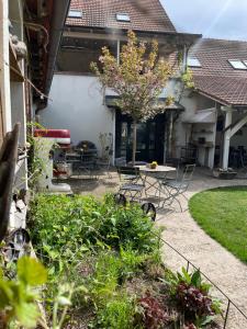 a patio with a table and chairs in a yard at Penzion Lívanec in Horní Bezděkov