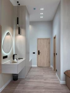 a hallway with a vanity and a mirror and a door at Small Cozy Spa Hotel in Aktobe +15 photos
