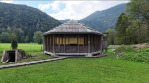 a small building in the middle of a field at IškAAdventure-appertment in Ig