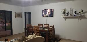 a living room with a dining room table and chairs at Zebra game farm in Brits