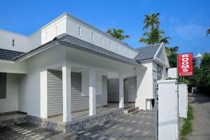 a white house with a sign in front of it at RAGAM RESORT in Alleppey +22 photos