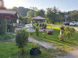 a garden with a gazebo in the grass at Pension Hutterer in Scharnstein