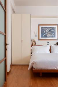 a bedroom with a white closet and a bed at Residence Verdeluna in Marina di Pietrasanta