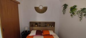 a bedroom with a bed and a mirror on the wall at Casa da Capinha Rota - Moura in Moura