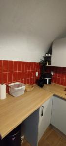 a kitchen with a wooden counter and red tiles at Casa da Capinha Rota - Moura in Moura