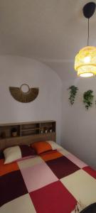 a bedroom with a bed with a checkered floor at Casa da Capinha Rota - Moura in Moura +4 photos