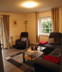 a living room with a couch and a table at "Am Waldesrand" RE16 in Sögel
