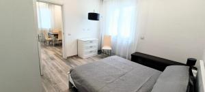 a bedroom with a bed and a dresser and a table at Chez Romeo in Ravenna