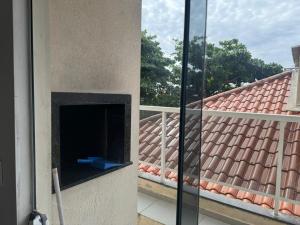a balcony with a fireplace and a roof at Apartamento 70 metros do mar in Florianópolis +115 photos