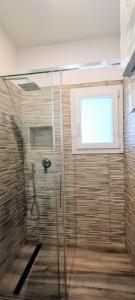 a bathroom with a shower with a window at Chez Romeo in Ravenna