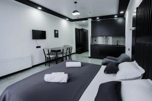 a bedroom with a bed with two towels on it at Апарт-отель Homeland in Gonio +27 photos