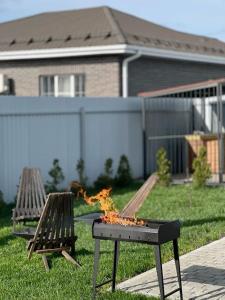 a table with a pizza on it in a backyard at İvanovka Eco Home in İvanovka