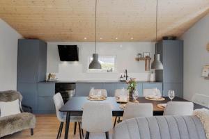 a kitchen and dining room with a table and chairs at OH585-Hadsund-Brondbaekken-34 in Øster Hurup