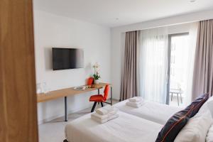 a hotel room with two beds and a desk at Zyra Hotel St Julians - Adults only in St. Julianʼs +53 photos