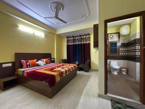 a bedroom with a king sized bed and a bathroom at Indu BNB Shimla in Shimla