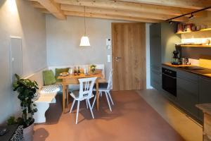 a kitchen and dining room with a table and chairs at Studio Apartment Lindennest in Waging am See