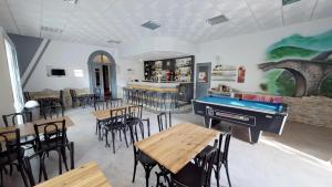 a restaurant with a pool table and tables and chairs at Hotel restaurant LAISSAC SPEISER in Olargues