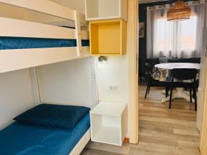 a small room with a bunk bed and a table at Sardegna selvaggia a due passi dal mare in Vignola Mare +58 photos