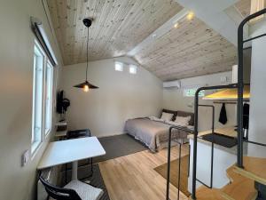 a bedroom with a bed and a desk in a room at Central, Modern, Cozy Cottage in Gävle