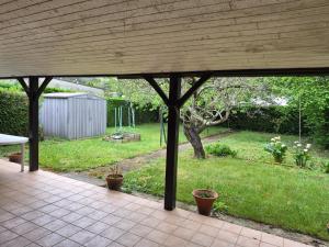 a screened porch with a view of a yard at Les pins in Mulsanne