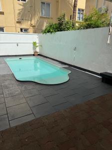 a blue tub sitting on top of a tiled patio at Coco villa in Flic-en-Flac