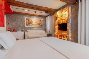 a bedroom with a white bed and a fireplace at Ares Venice Bed & Relais in Venice