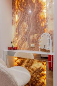 a table and a chair in a room with a wall at Ares Venice Bed & Relais in Venice +167 photos