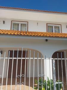 a white fence in front of a house at Coco villa in Flic-en-Flac
