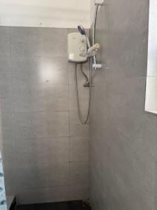 a shower in a bathroom with a shower head at Coco villa in Flic-en-Flac +10 photos