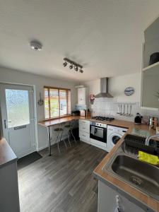 a kitchen with a sink and a counter top at 34 Surfview Beach House in Newquay